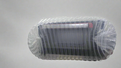 Futon covered with clear plastic wrap on a white background